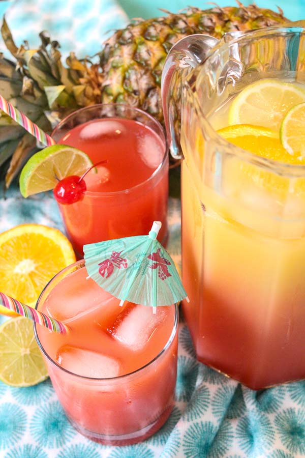 pitcher of tropical rum punch with fresh fruit garnish