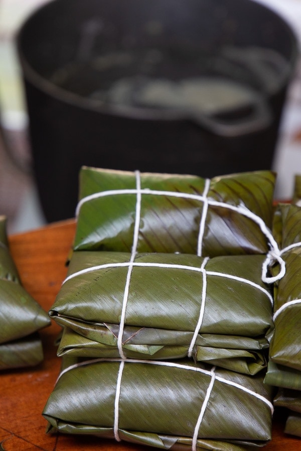 Stacks of leaf-packaged Costa Rican tamales.