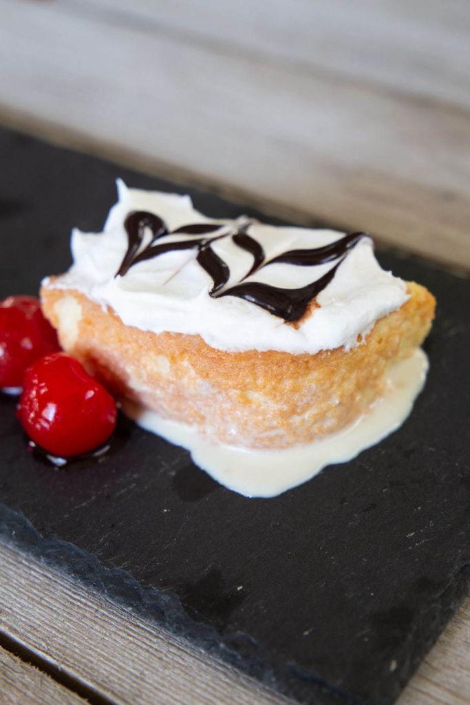 moist tres leches cake with cherries and chocolate