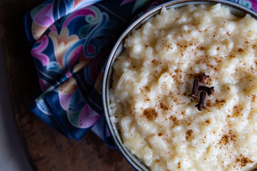 cropped close up view of arroz con leche and pastel colored scarf.