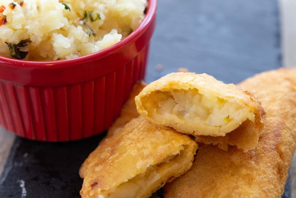 Close-up of halved potato empanada.