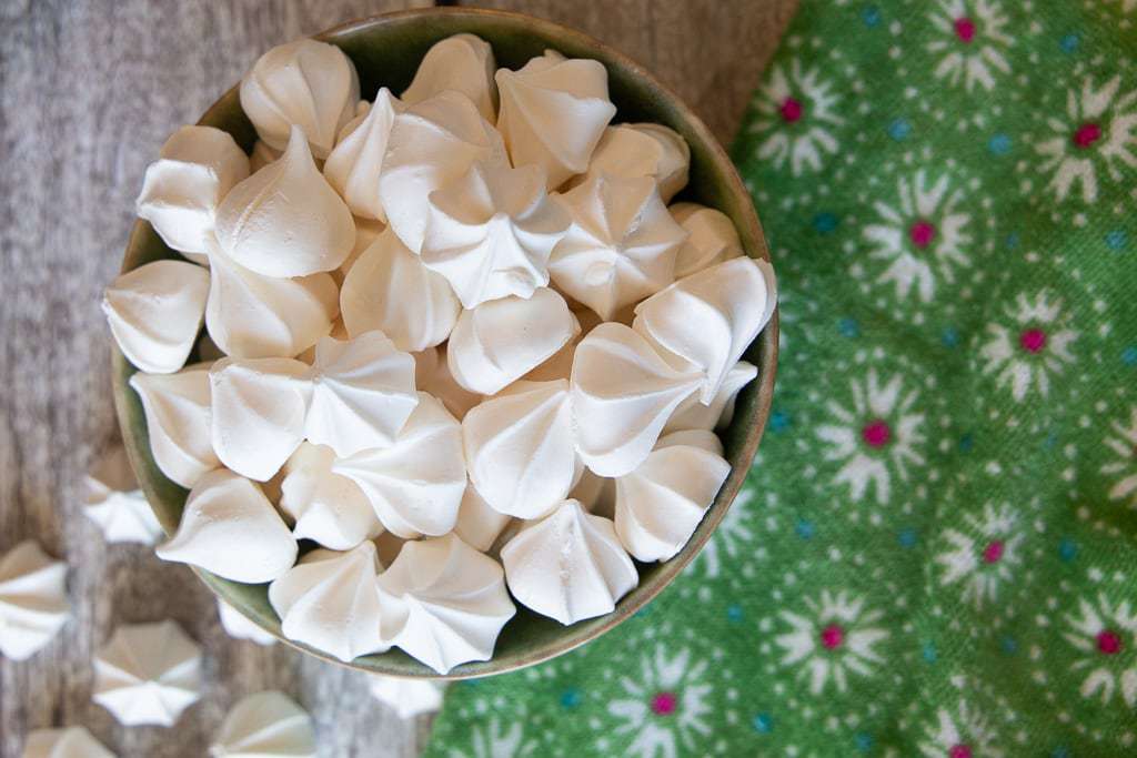 Bowl of small white meringue cookies.